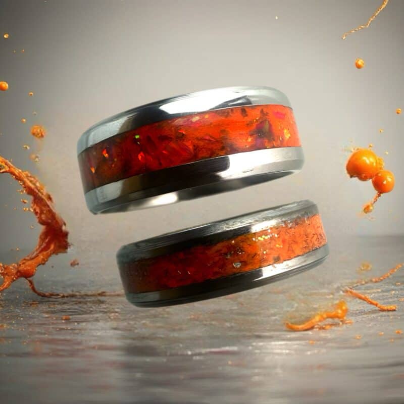 The Showgirl, orange ring with opal and mica powder shown with orange paint splashes.