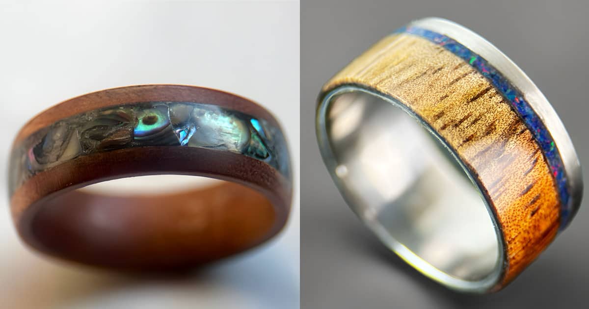 Wood anniversary gift ideas: koa ring with abalone inlay and a koa ring with opal inlay and stainless steel core.