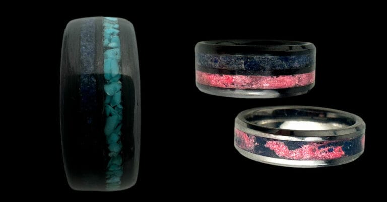 Memorial jewelry. Three rings for men and women. Far left is a black carbon fiber ring with turquoise and blue powder. Top right is black ceramic with blue and pink powder bands. Bottom right is tungsten single channel ring with pink and blue swirls.