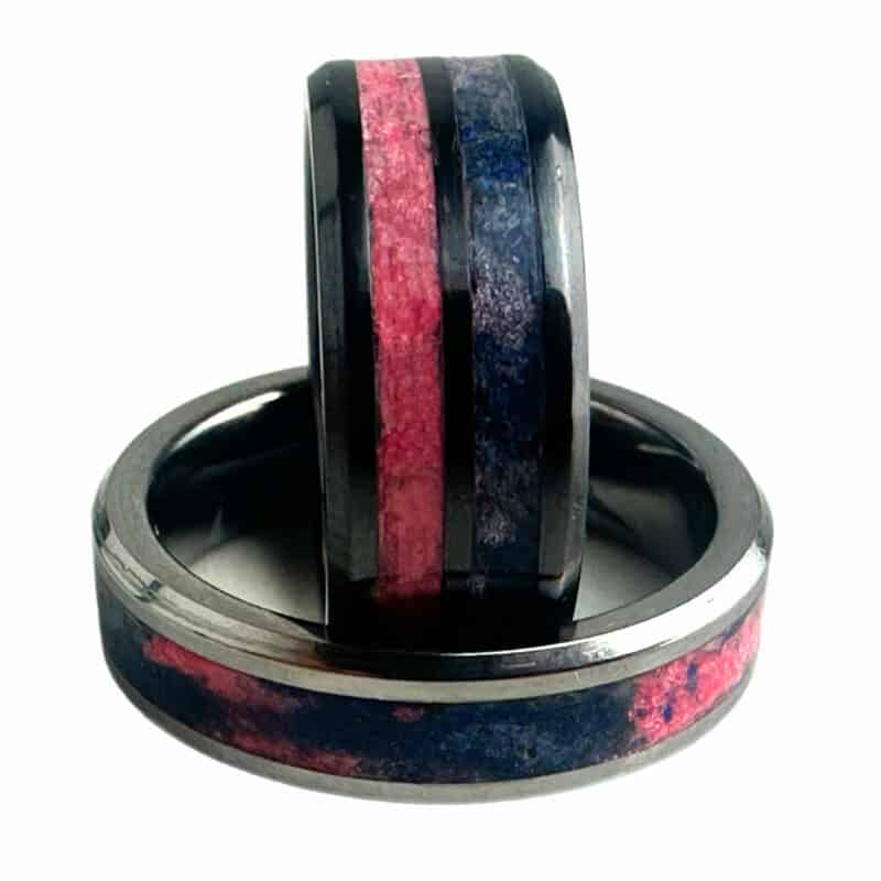 Pregnancy and infant loss awareness rings. Black ceramic with blue and pink inlays. Tungsten ring with swirled blue and pink inlay in single channel.