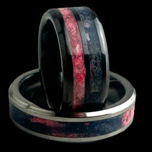 Pregnancy and infant loss awareness rings. Black ceramic with blue and pink inlays. Tungsten ring with swirled blue and pink inlay in single channel.