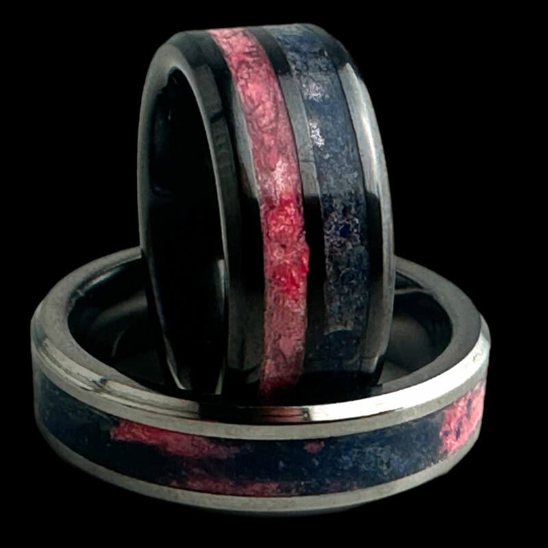 Pregnancy and infant loss awareness rings. Black ceramic with blue and pink inlays. Tungsten ring with swirled blue and pink inlay in single channel.