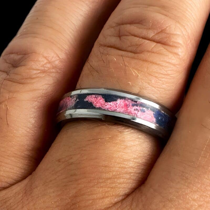 Pregnancy and infant loss awareness ring.Tungsten ring with swirled blue and pink inlay in single channel on a finger.