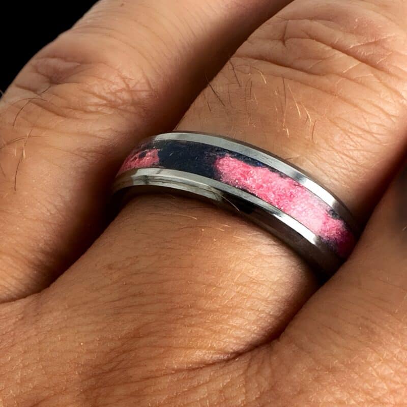 Pregnancy and infant loss awareness ring.Tungsten ring with swirled blue and pink inlay in single channel on a finger.