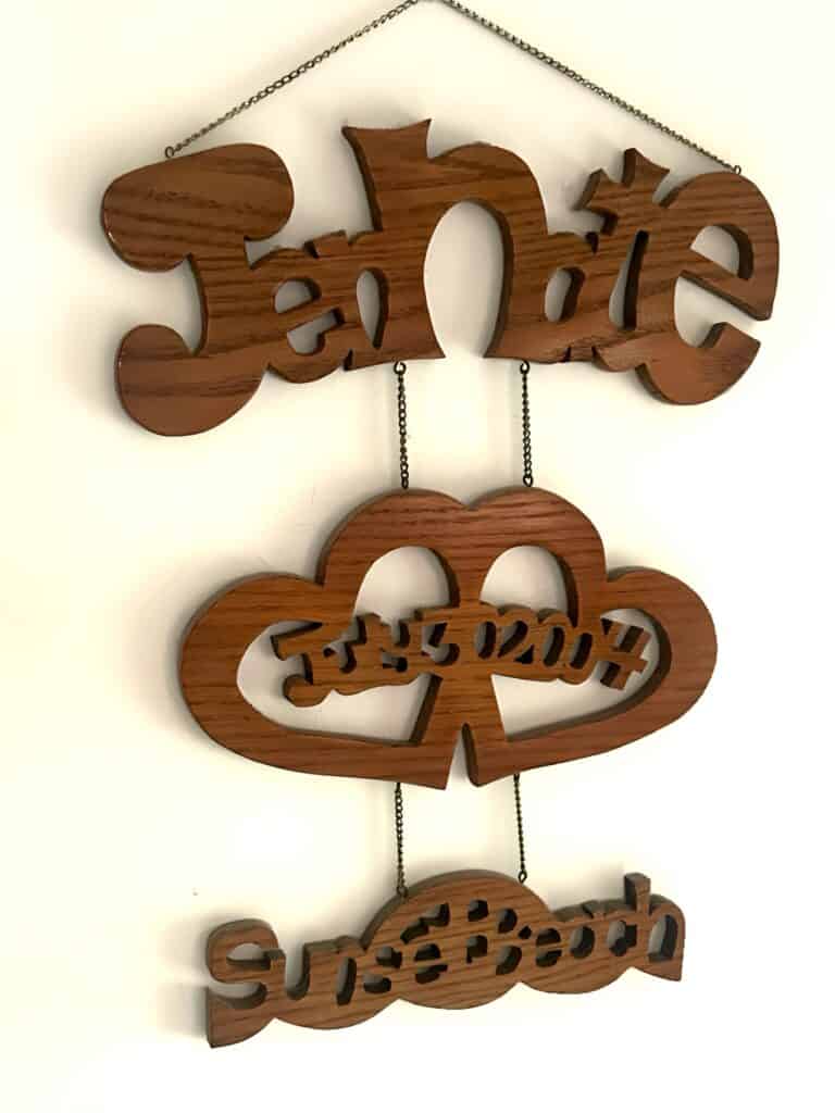 Wood anniversary gift ideas. Picture of a sign that reads Jennate, July 30, 2004, sunsetbeach