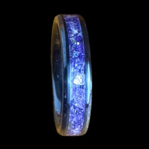 Purple glass ring. Black ceramic core. Set on a black background.