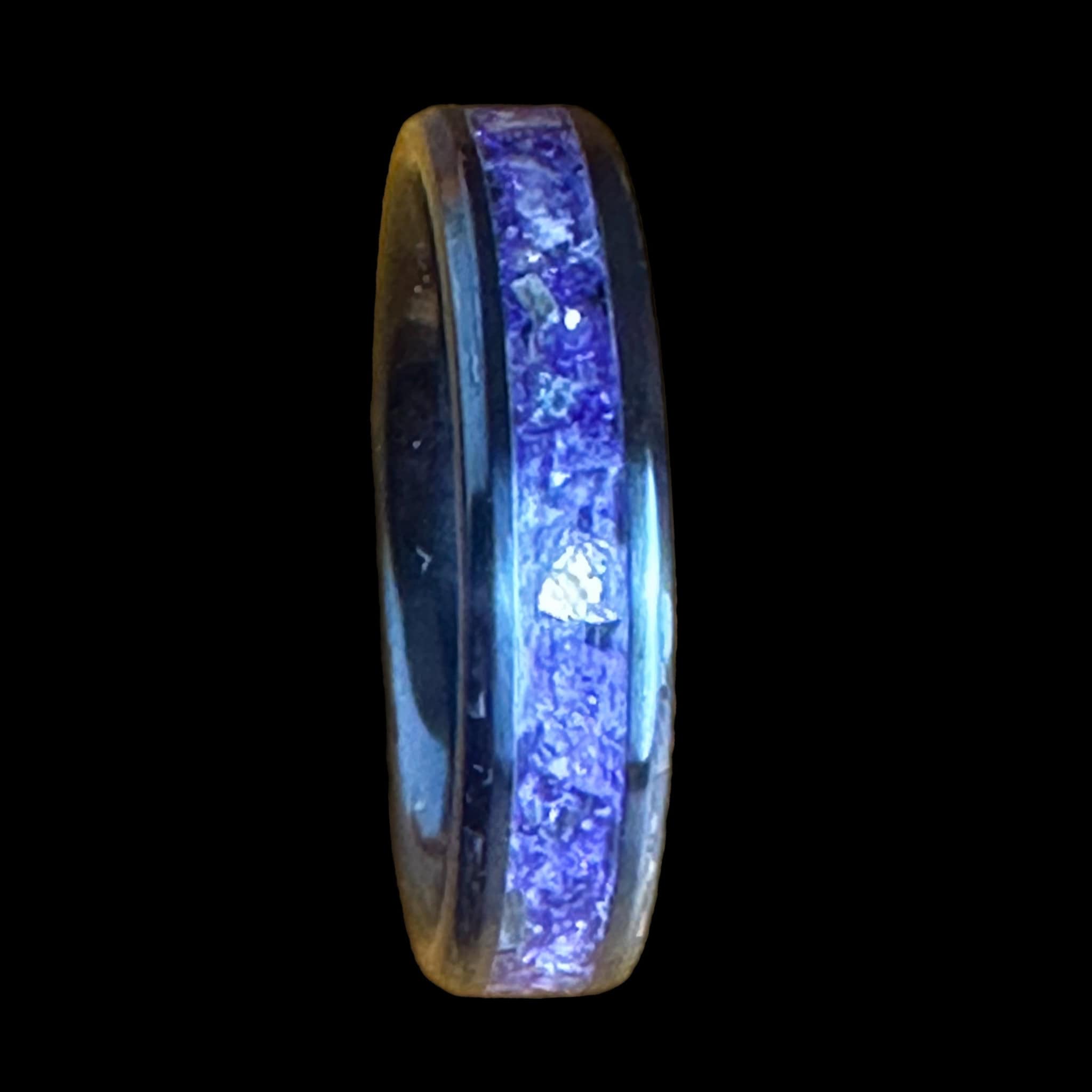Purple glass ring. Black ceramic core. Set on a black background.
